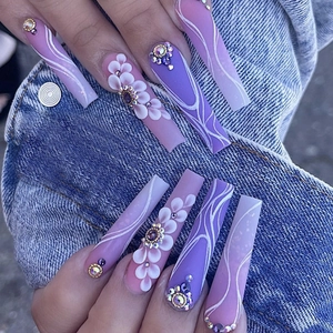 Close-up of extra long ballerina press on nails with purple gradients and 3D floral art