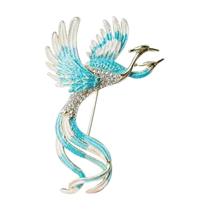 Exquisite phoenix brooch with blue enamel and sparkling crystals on white background