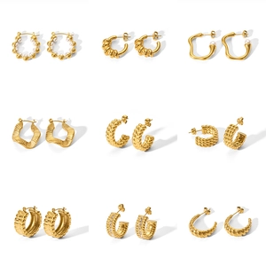 Set of nine golden stainless steel hoop earrings featuring pearl and diamond accents