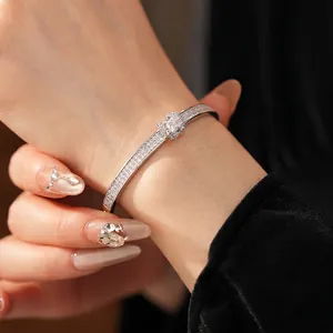 Elegant silver pavé diamond oval clasp bracelet with center square stone in a luxury style