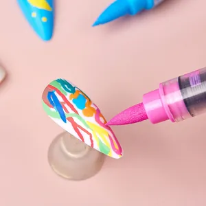 Water-based acrylic nail art pen for DIY manicures with pink tip on white nail tips