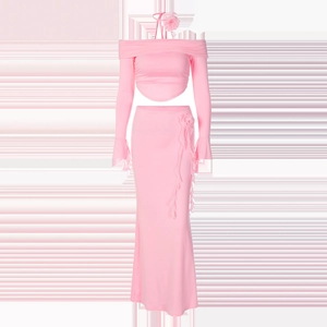 Close-up of pink two-piece set featuring off-shoulder top and skirt with floral accent