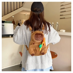 Cute brown plush Capybara backpack with an orange flower detail shown in a cafe setting