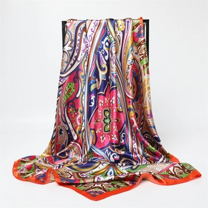 Detail of colorful paisley satin scarf with elegant drape and vibrant silk-like sheen