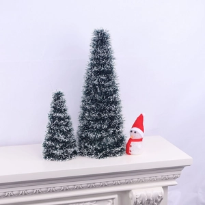 Christmas decoration set with two snowy sisal trees and a snowman on a white fireplace mantel