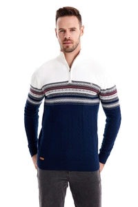 Detail of navy and white knit sweater featuring geometric patterns and ribbed cuffs