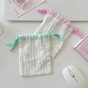 Polka dot cotton drawstring pouches in pink and green for small items organization