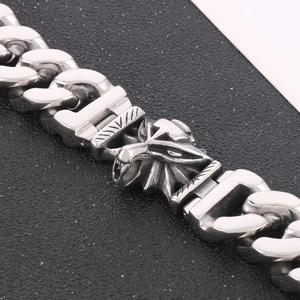 Detailed close-up of a silver wolf head charm on a vintage polished titanium steel chain