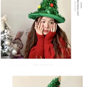 Detail of green sequin Christmas tree hat with colorful pom-poms on a female model