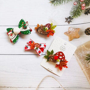 Close-up of felt Christmas hair clips with santa and hedgehog designs for girls