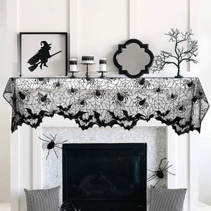 Detail of black lace fireplace scarf with spider web and bat patterns for Halloween decor
