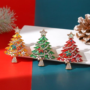 Detailed view of colorful Christmas tree brooches with rhinestones and pearl accents