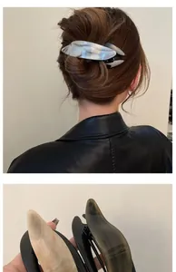Detail of acetate hair clips with marble texture for elegant updo hairstyles