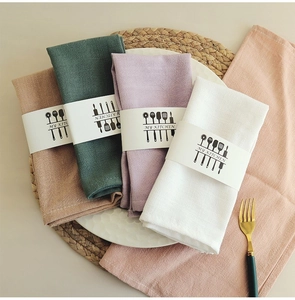 Detail of waffle weave cotton linen napkins in white, purple, green, and brown colors