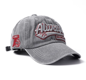 Detailed close-up of washed gray cotton baseball cap with red New York City embroidery