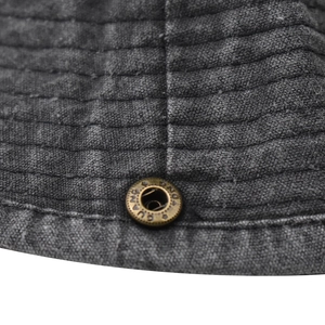 Macro shot of washed cotton fabric with stitched lines and antique bronze metal eyelet