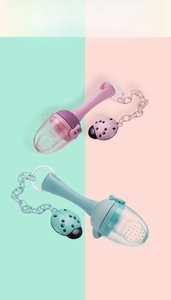 Detail of baby fruit feeder with silicone mesh bag and ladybug pacifier clip