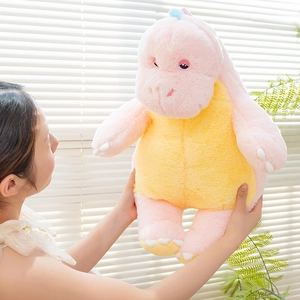 Close-up of soft pink dinosaur plush toy showing high quality embroidery and texture
