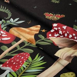 Detailed close-up of mushroom and butterfly print on soft velvet tapestry fabric