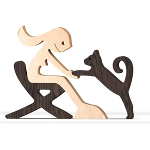 Handcrafted minimalist wood carving of a person sitting on a chair with a pet dog