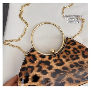Close-up of leopard print evening bag featuring a gold round handle and chain strap