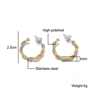 Macro detail of two-tone twisted 18K gold plated stainless steel hoop with 2.5cm size mark
