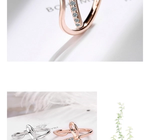 Detail view of adjustable silver and rose gold bow rings with shimmering micro diamonds