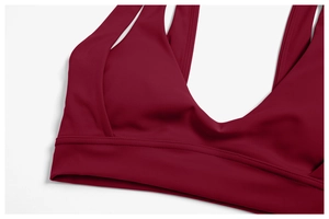 Detailed close-up of wine red yoga top featuring premium stitching and matte fabric texture
