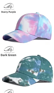 Detail view of cotton tie-dye baseball caps in starry purple and dark green patterns