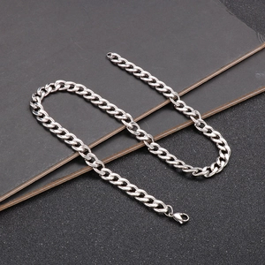 Detailed view of polished silver stainless steel Cuban link chain with lobster clasp