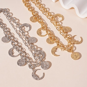 Vintage gold and silver layered necklace with sun and moon pendants on thick chains