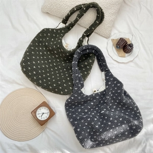 Top view of two lamb fleece tote bags in green and blue with white polka dot patterns