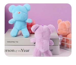 Detailed view of colorful plush bear keychains in blue, purple and pink colors