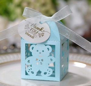 Detail of light blue hollow bear candy box with white silk ribbon and Thank You tag