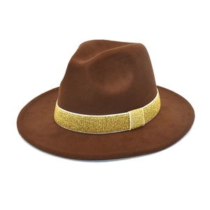 Detailed texture of brown wool felt fedora featuring a gold glitter ribbon trim