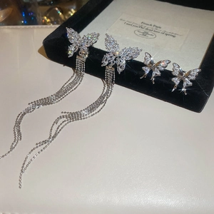 Detailed macro view of silver zircon butterfly tassel earrings with delicate micro-pave setting