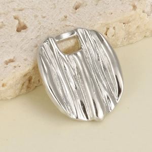 Close-up of silver vertical textured pendant accessory with an irregular metallic finish