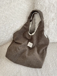 Floral corduroy tote bag in dark coffee brown with vintage sozakka logo on plush background