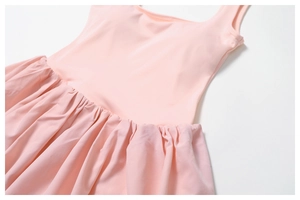 Close-up of pink sports dress showing square neckline and pleated waist texture