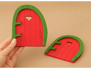 Detail of red wooden dollhouse miniature doors with heart cutouts for Christmas decor