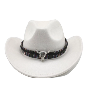Detail of white wide-brim western cowboy hat with ethnic band and silver bull skull charm
