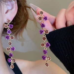 Detailed close-up of French vintage rose pendant earrings with sparkling crystals