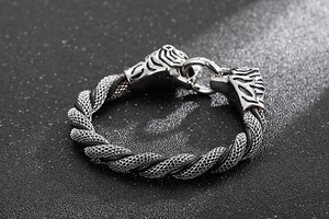 Macro view of silver leopard head punk bracelet with black woven rope texture