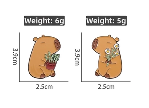 Macro detail of enamel capybara pins showing dimensions of 3.9cm x 2.5cm and weights