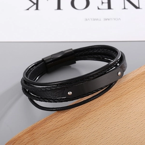 Detail of multi-layer black leather braided bracelet with blank metal plate and magnetic clasp