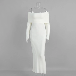 Detail of white off-shoulder knitted maxi dress featuring thick ribbed texture and slim fit