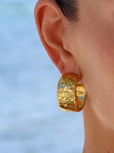 Macro shot of 14K gold-plated stainless steel earrings with textured hammered finish