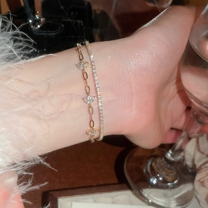 Close-up of 18k gold plated double-layer floral bracelet set with shiny zircon stones