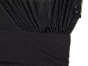 Detailed macro view of black mesh fabric with pleated texture and stretch stitching