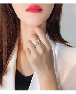 Close-up of 925 silver irregular hollow woven ring with geometric texture on finger